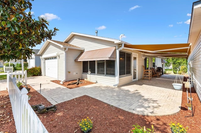 1736 Watts Mill Way, The Villages, FL 32162 - rear view of house featuring a garage, a sunroom, and fence