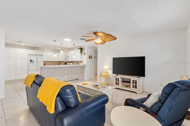 1736 Watts Mill Way, The Villages, FL 32162 - living room featuring light tile patterned floors, a ceiling fan, recessed lighting, and a textured ceiling