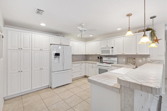 1736 Watts Mill Way, The Villages, FL 32162 - kitchen featuring white appliances, a peninsula, a sink, recessed lighting, and a ceiling fan