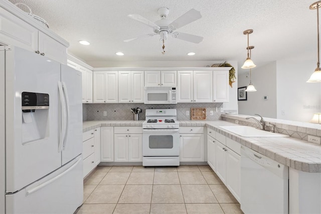 1736 Watts Mill Way, The Villages, FL 32162 - kitchen featuring white appliances, a sink, a peninsula, white cabinets, and recessed lighting