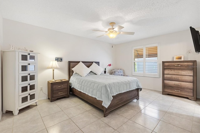 1736 Watts Mill Way, The Villages, FL 32162 - bedroom with light tile patterned floors, baseboards, ceiling fan, and a textured ceiling