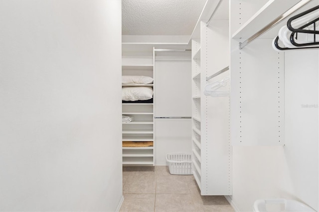 1736 Watts Mill Way, The Villages, FL 32162 - walk in closet featuring light tile patterned floors