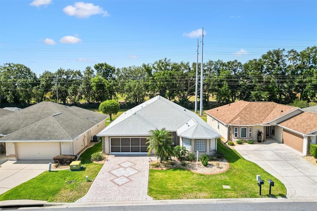 view of front of house with driveway, a garage, and a front yard