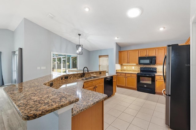 kitchen featuring black appliances, a sink, lofted ceiling, backsplash, and a large island