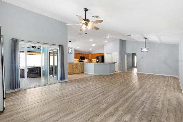 unfurnished living room featuring ceiling fan, arched walkways, high vaulted ceiling, light wood-style flooring, and recessed lighting