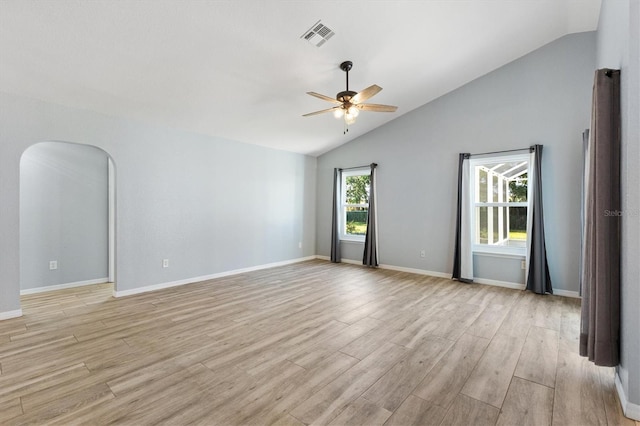spare room featuring ceiling fan, light wood-style flooring, baseboards, and high vaulted ceiling
