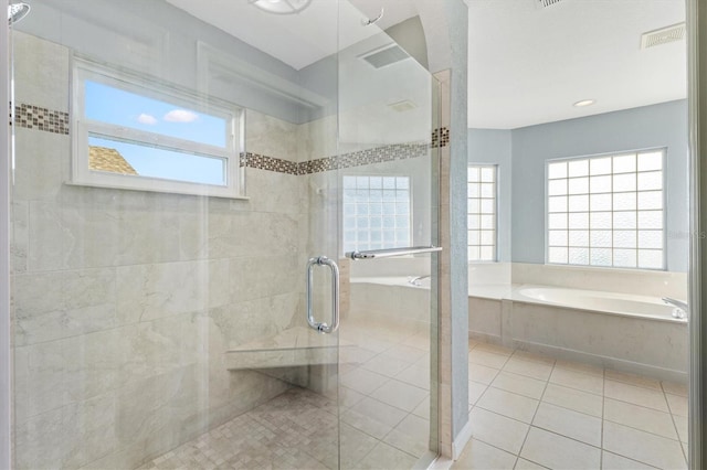 bathroom with a garden tub, a stall shower, and tile patterned floors