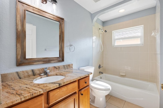 full bathroom featuring toilet, washtub / shower combination, tile patterned floors, vanity, and a textured wall