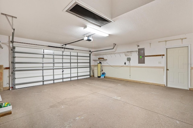 garage featuring a garage door opener and electric panel