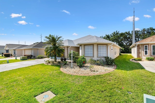 ranch-style home with a front yard, stucco siding, and driveway
