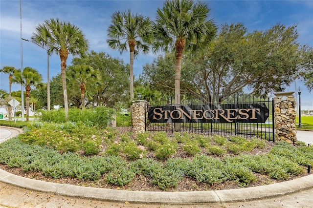 community sign featuring fence