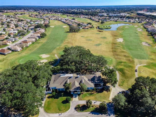 aerial overview of property's location featuring nearby suburban area, a nearby body of water, and a golf course