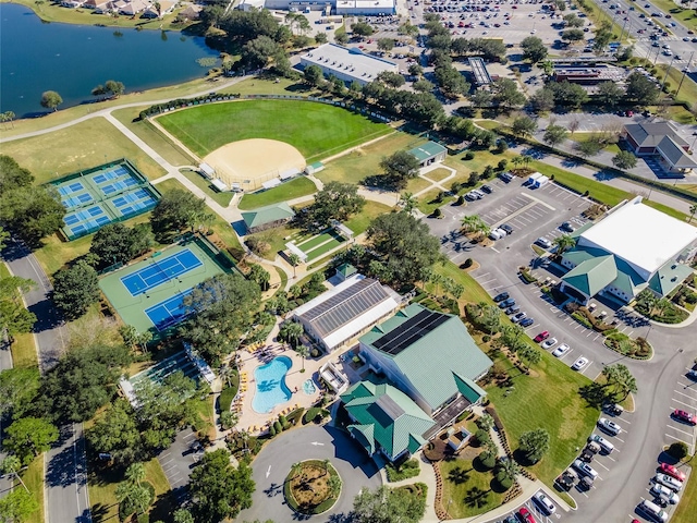 aerial overview of property's location featuring a nearby body of water and a pool