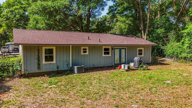 5737 NW 65th Pl, Ocala, FL 34482 - rear view of property featuring central air condition unit, a lawn, and a shingled roof