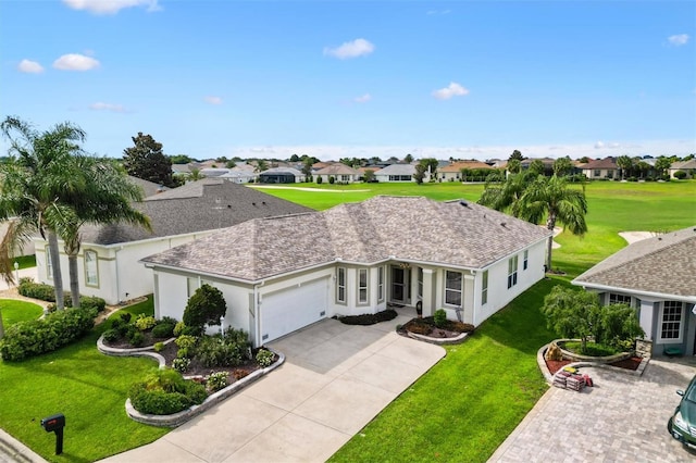 view of front of home with an attached garage, a residential view, concrete driveway, a front lawn, and stucco siding