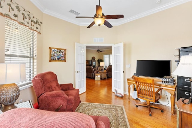 office area featuring french doors, ornamental molding, wood finished floors, ceiling fan, and healthy amount of natural light