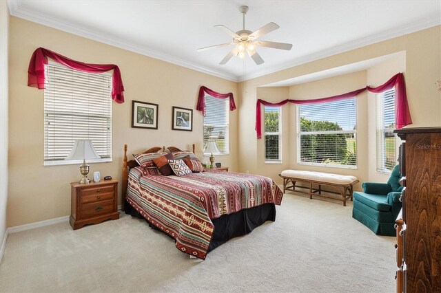 bedroom featuring carpet flooring, crown molding, ceiling fan, and baseboards
