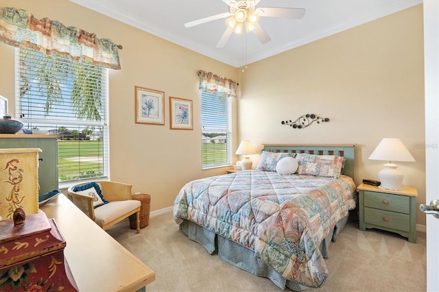 bedroom featuring carpet floors, baseboards, ornamental molding, and a ceiling fan