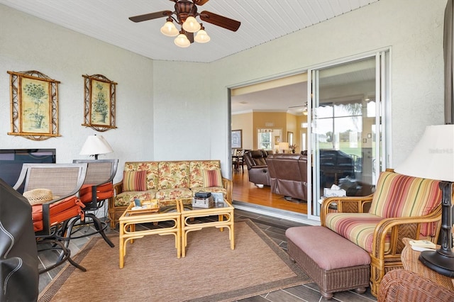 sitting room with a ceiling fan and wood finished floors