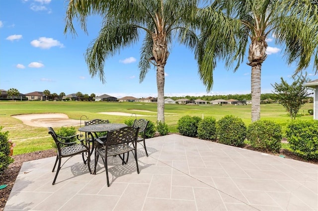 view of patio with a residential view, golf course view, and outdoor dining area