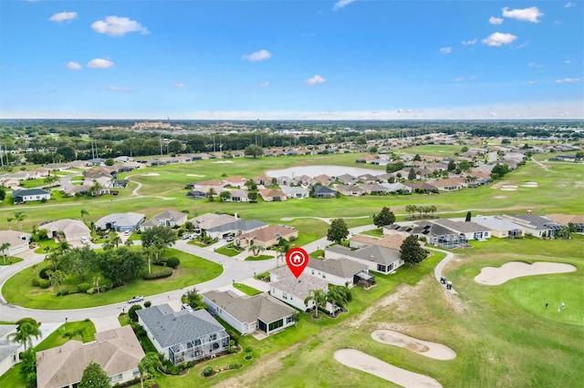 aerial view of residential area featuring a golf course