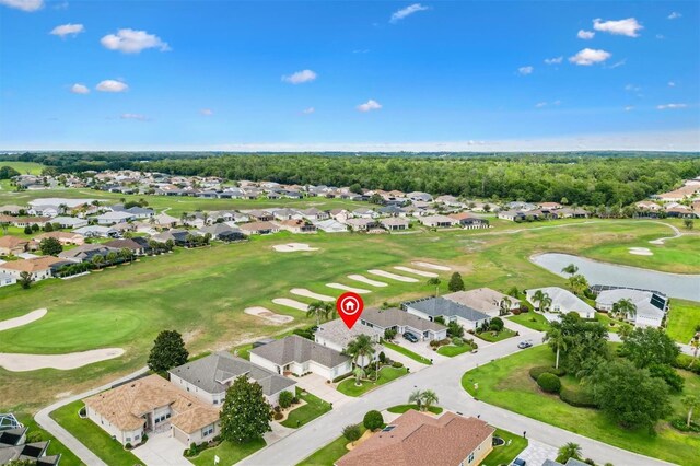 aerial view of property and surrounding area with nearby suburban area and a golf club
