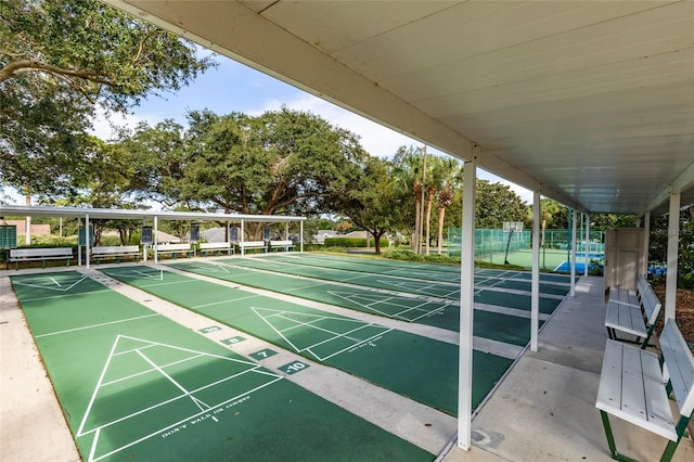surrounding community featuring fence and shuffleboard