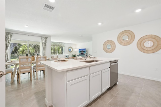 kitchen featuring a sink, visible vents, dishwasher, white cabinetry, and light tile patterned floors