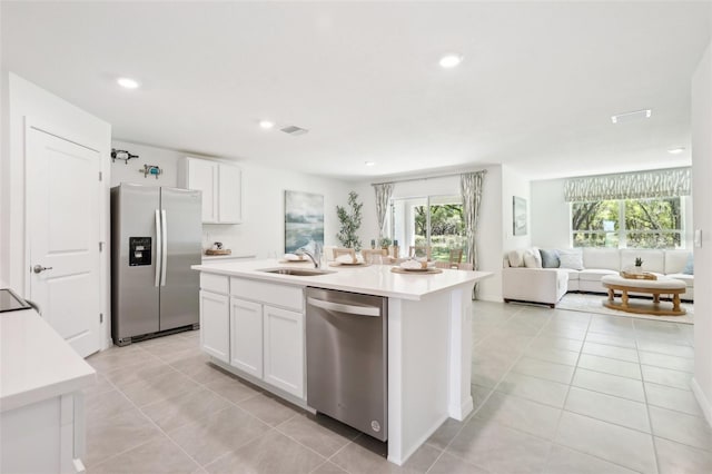 kitchen featuring light tile patterned floors, visible vents, a sink, open floor plan, and appliances with stainless steel finishes