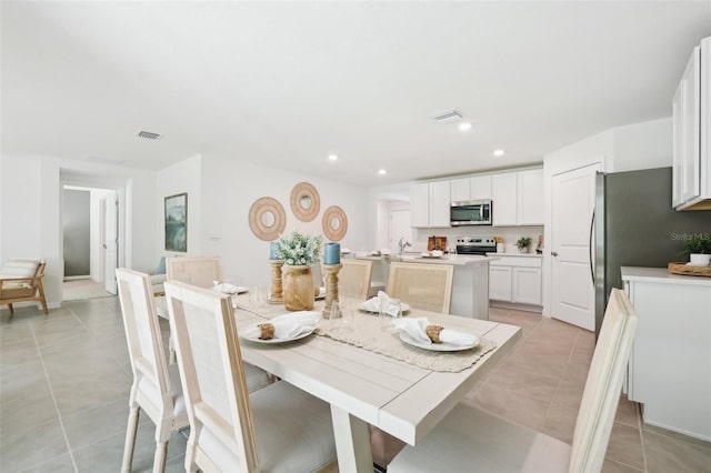 dining room with recessed lighting, light tile patterned floors, and visible vents