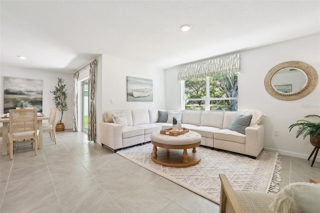 living room featuring light tile patterned floors, a healthy amount of sunlight, and recessed lighting