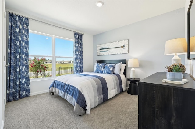 carpeted bedroom featuring baseboards