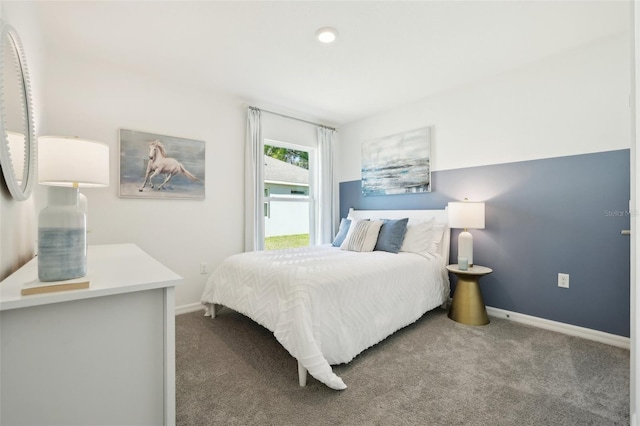 carpeted bedroom featuring baseboards