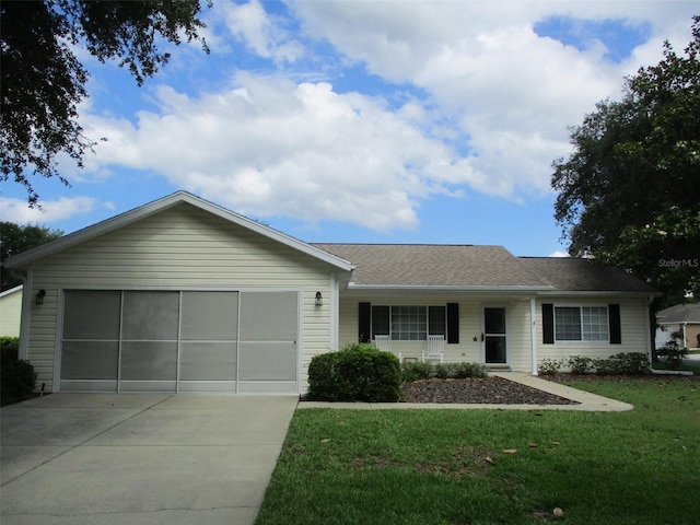 single story home featuring concrete driveway, a garage, and a front yard