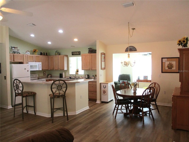 kitchen with a sink, white appliances, visible vents, recessed lighting, and dark wood-style floors