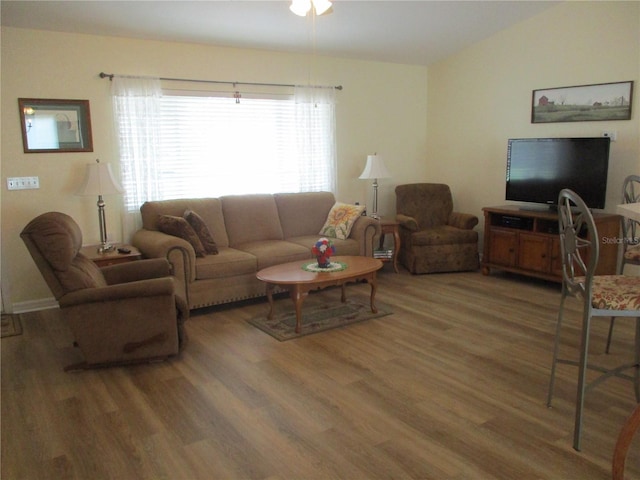 living room featuring a wealth of natural light, light wood-type flooring, and a ceiling fan