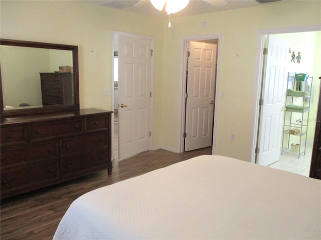 bedroom with ceiling fan, connected bathroom, and wood finished floors