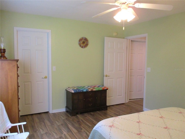 bedroom with baseboards, wood finished floors, and a ceiling fan