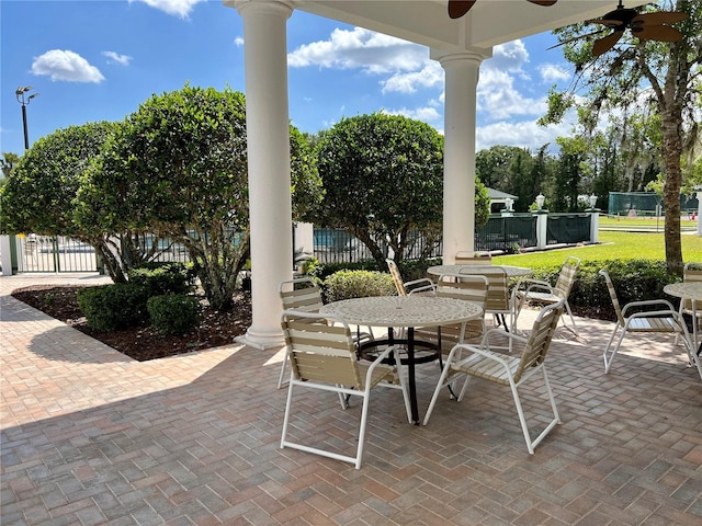 view of patio featuring ceiling fan, fence, and outdoor dining space