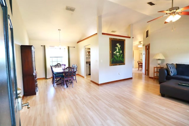 5351 SW 80th Pl, Ocala, FL 34476 - living area with ceiling fan, light wood-style flooring, a chandelier, high vaulted ceiling, and baseboards