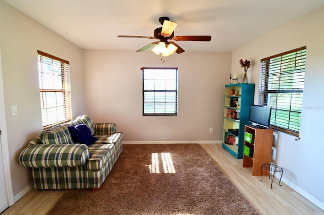 5351 SW 80th Pl, Ocala, FL 34476 - living area featuring plenty of natural light, a ceiling fan, wood finished floors, and baseboards