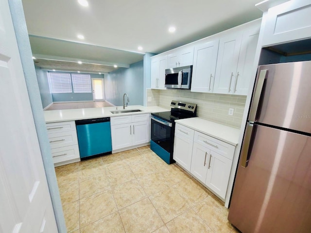 kitchen featuring stainless steel appliances, a sink, decorative backsplash, white cabinets, and light countertops