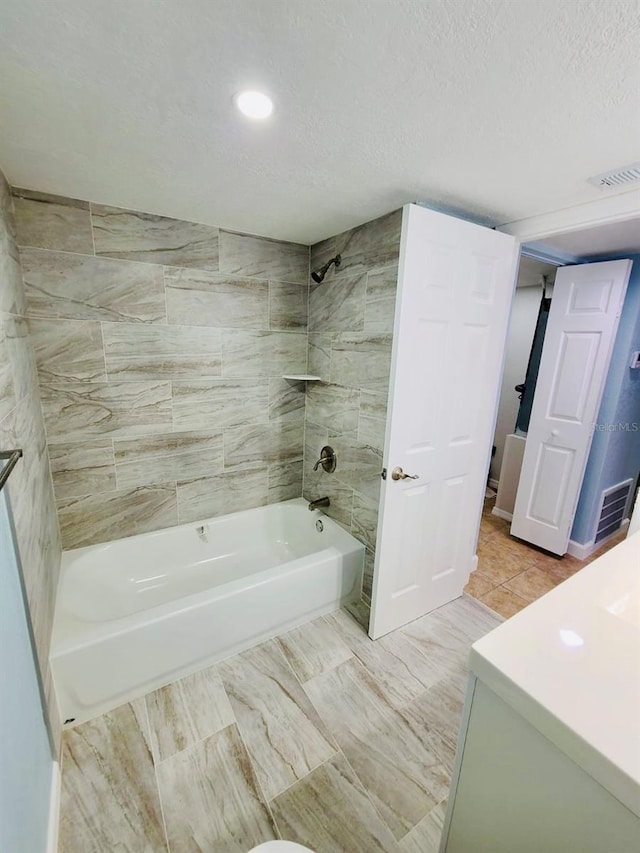 bathroom featuring shower / bath combination, recessed lighting, and a textured ceiling