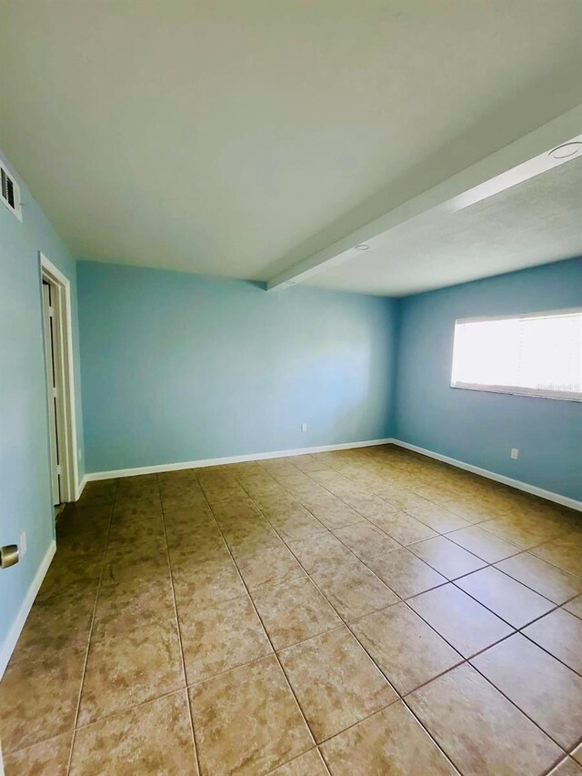 tiled empty room with baseboards