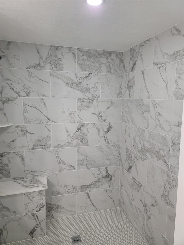 full bath featuring a tile shower