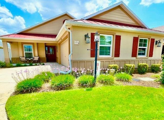 3023 Charlevoix St, The Villages, FL 32163 - view of front of property featuring an attached garage, a front lawn, and stucco siding