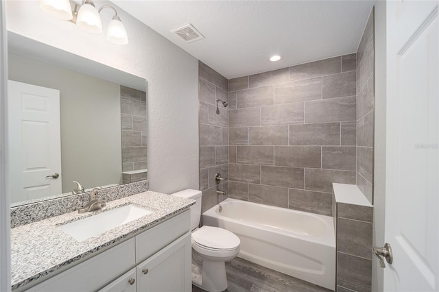 23163 NW Shamrock Ave, Dunnellon, FL 34431 - full bathroom featuring wood finished floors, toilet, bathtub / shower combination, vanity, and recessed lighting