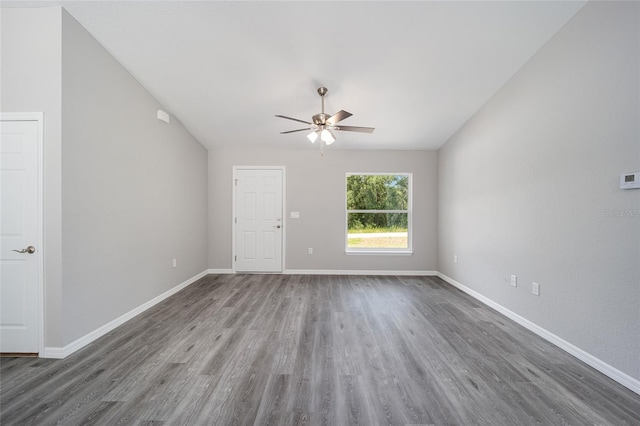 23163 NW Shamrock Ave, Dunnellon, FL 34431 - unfurnished living room with a ceiling fan, wood finished floors, baseboards, and lofted ceiling