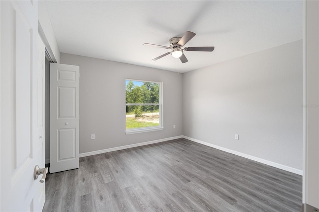 23163 NW Shamrock Ave, Dunnellon, FL 34431 - spare room featuring ceiling fan, wood finished floors, and baseboards