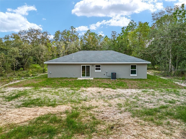 23163 NW Shamrock Ave, Dunnellon, FL 34431 - rear view of property with central AC and stucco siding